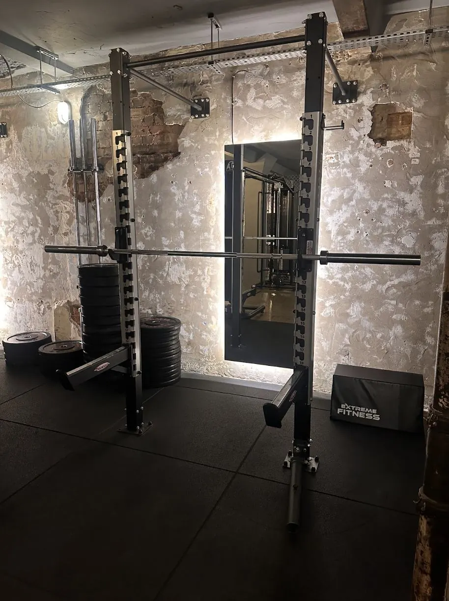 Amor Therapies and State of Change Clinic — Squat rack and plates against the original brickwork.